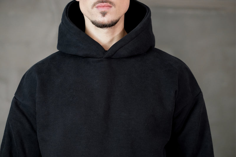 Ultra heavy black hoodie oversized with dropped shoulders silver cross at sleeve fabric close up